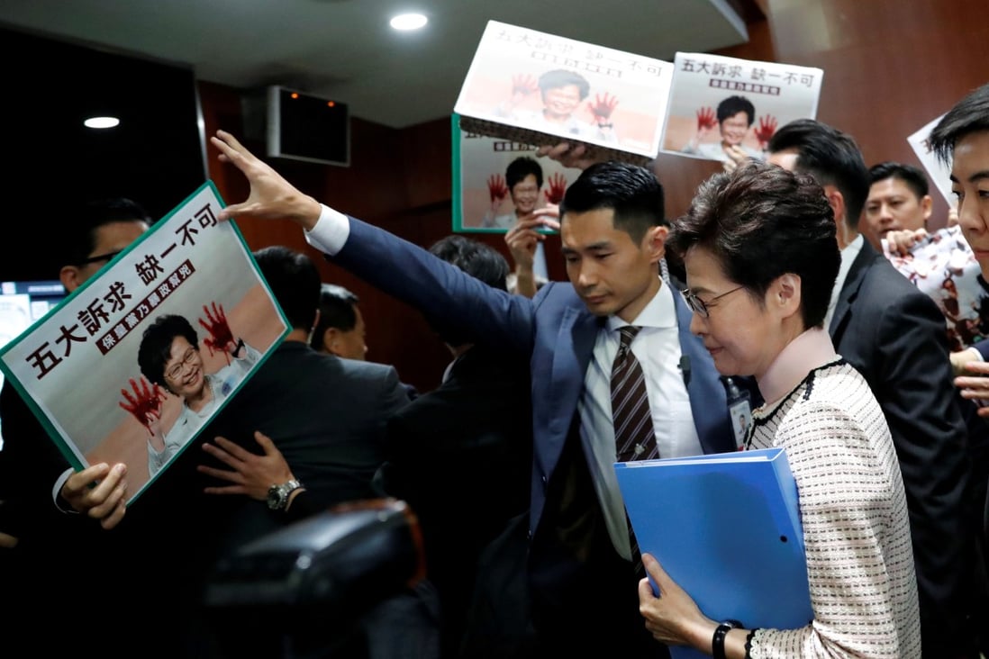 Opposition lawmakers raise protest slogans as Hong Kong Chief Executive Carrie Lam arrives at the Legislative Council on October 16 to present her annual policy address, which eventually had to be delivered via video. Photo: Reuters