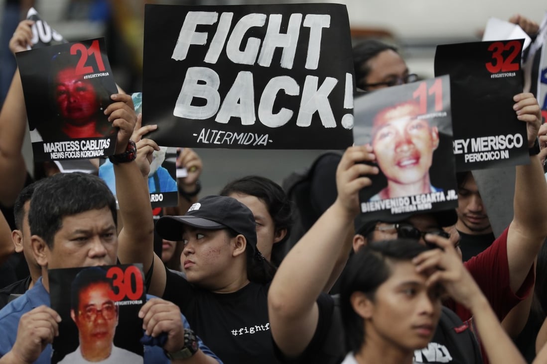Demonstrators hold pictures of victims on November 23 as they mark the 10th anniversary of the Maguindanao massacre in the Philippines. Photo: AP