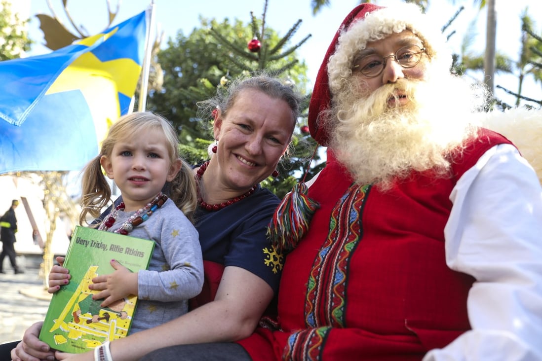 Swedish consul general Helena Storm with Father Christmasat the Hong Kong Cultural Centre Piazza in Tsim Sha Tsui. Photo: Dickson Lee