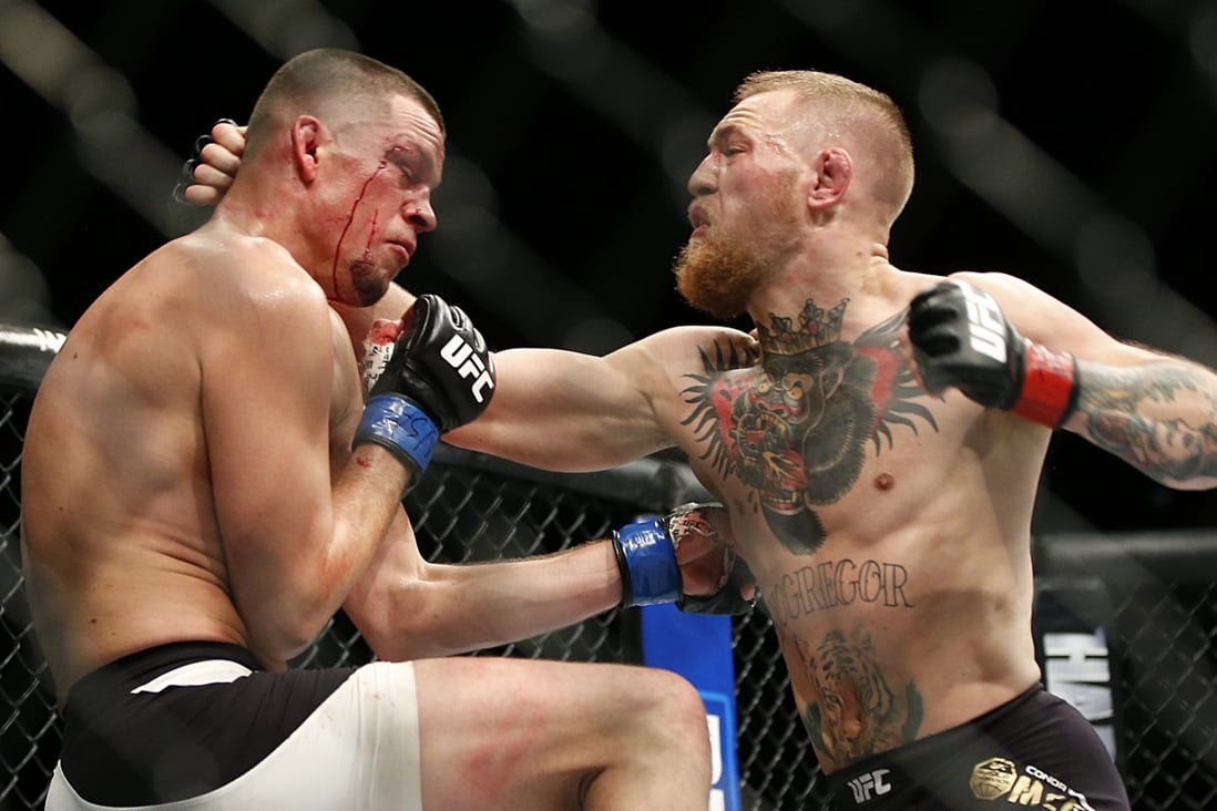 Conor McGregor (right) trades punches with Nate Diaz during UFC 196. Photo: AP