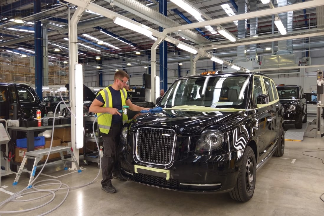 A worker polishes an electric-petrol hybrid taxi at the Zhejiang Geely's London Electric Vehicle Company factory in Coventry, middle England. Photo: SCMP / Eric Ng