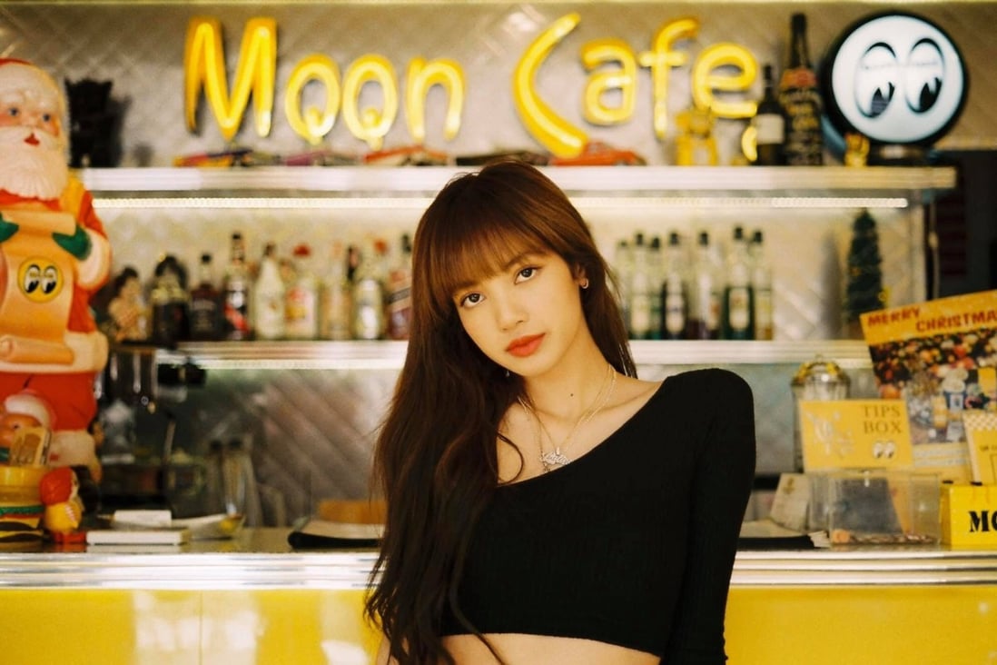 Lisa from K-pop girl group Blackpink, outside the Bangkok cafe that tried to sell her used cutlery and even a toilet seat.