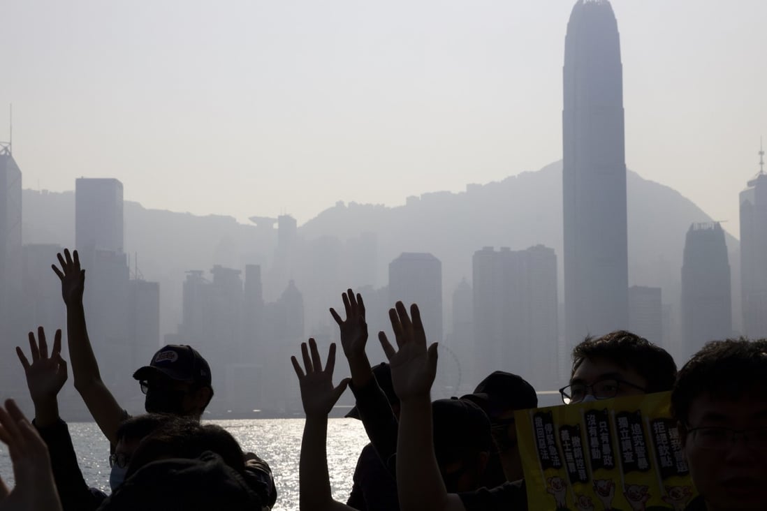 Protesters raise their hands to symbolise the five demands of the pro-democracy movement during a rally in Hong Kong on December 1. Photo: AP