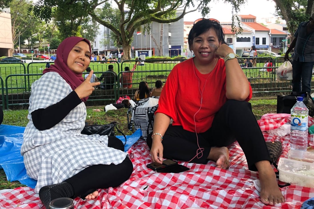 Indonesian domestic workers Sofia Marsudin, 49, and Sadiam Sadin, 47, enjoy a Sunday picnic. For many foreign workers in Singapore, it is difficult to find a safe and comfortable space to spend their day off. Photo: Kok Xinghui