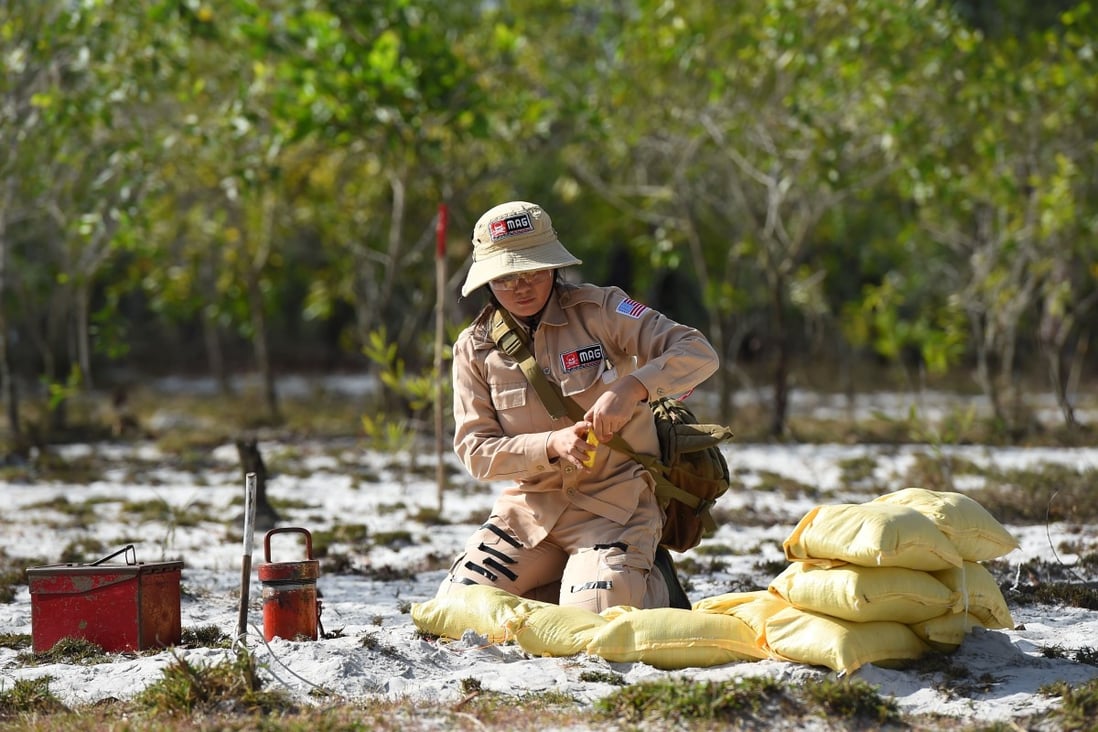 A deminer prepares to detonate unexploded ordnance at a site in Quang Tri province. Photo: AFP