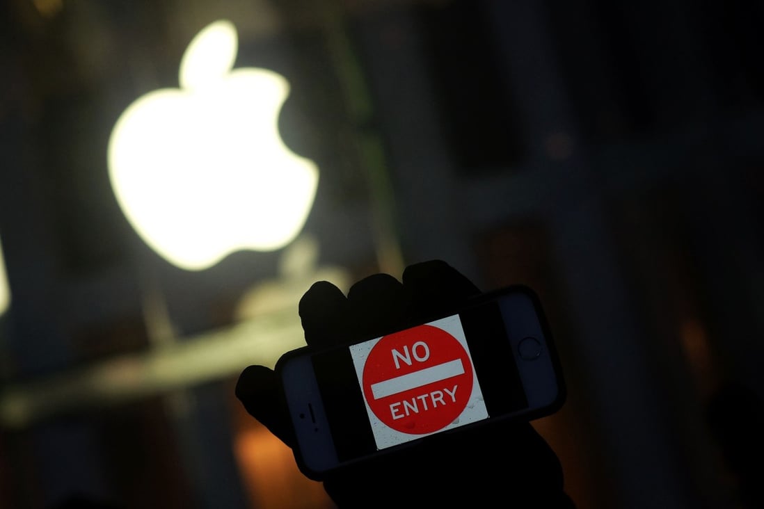 This file photo shows an anti-government protester holding his iPhone with a sign “No Entry” during a demonstration near the Apple Store on Fifth Avenue in New York. Photo: Agence France-Presse