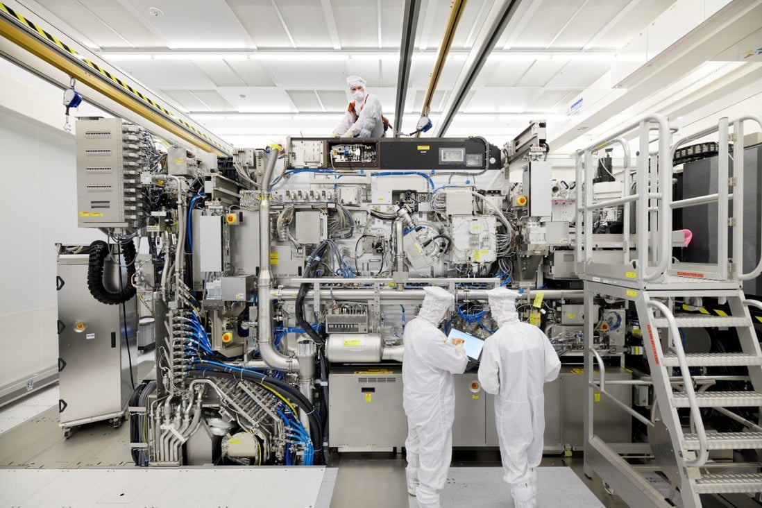 ASML employees are seen working on the final assembly of the company’s Twinscan NXE: 3400B extreme ultraviolet semiconductor lithography machine, with its panels removed, in Veldhoven, the Netherlands, on April 4, 2019. Photo: Reuters