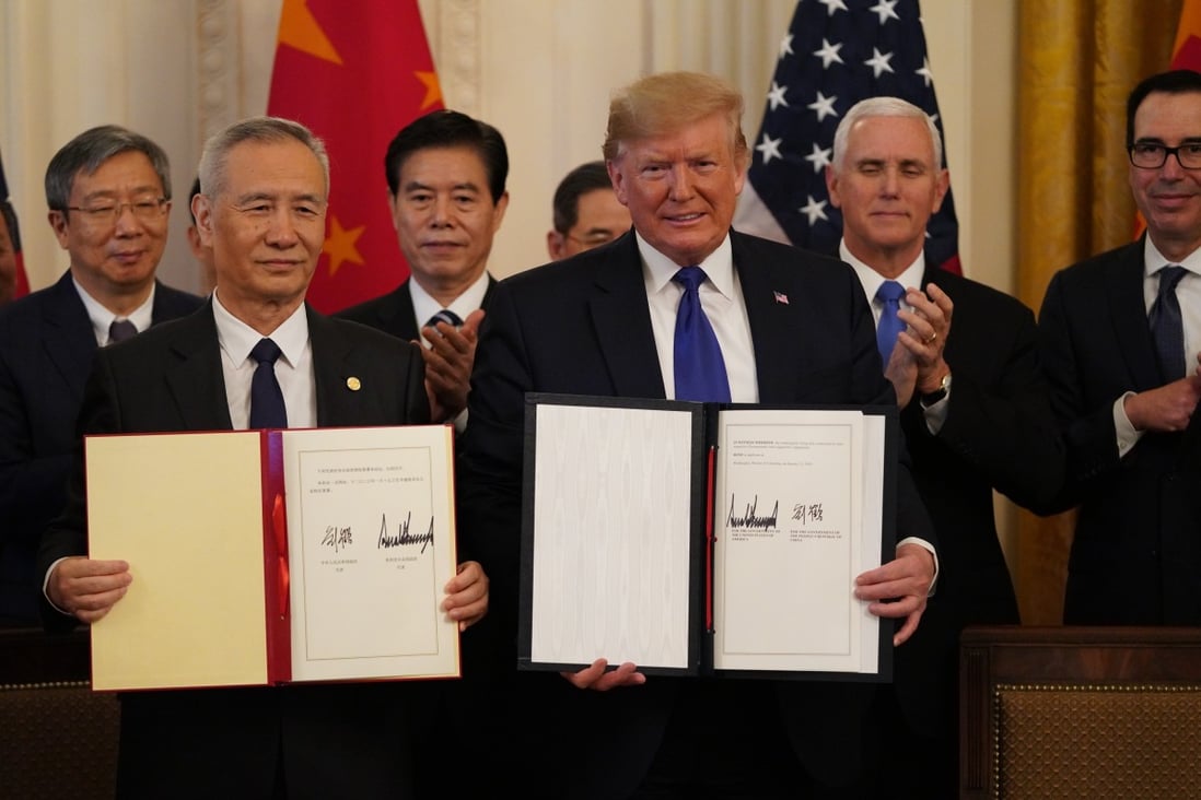 Chinese Vice-Premier Liu He and US President Donald Trump show their signed trade agreement during a ceremony at the White House in Washington on Wednesday. But American businesses say there is much more to get done. Photo: Xinhua