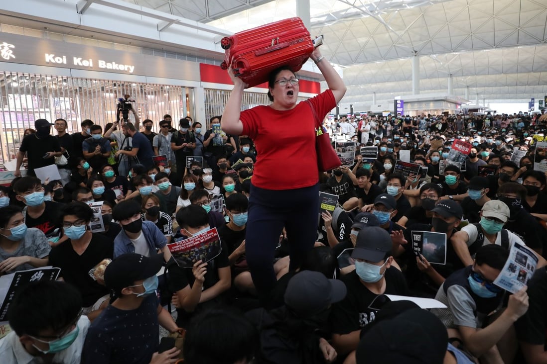 A traveller loses patience with protesters at Hong Kong airport, who occupied the site in August. Photo: Sam Tsang