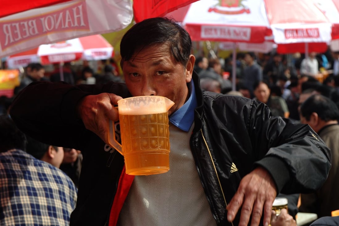 A Vietnamese man drinking during a local beer festival in Hanoi. Photo: AFP