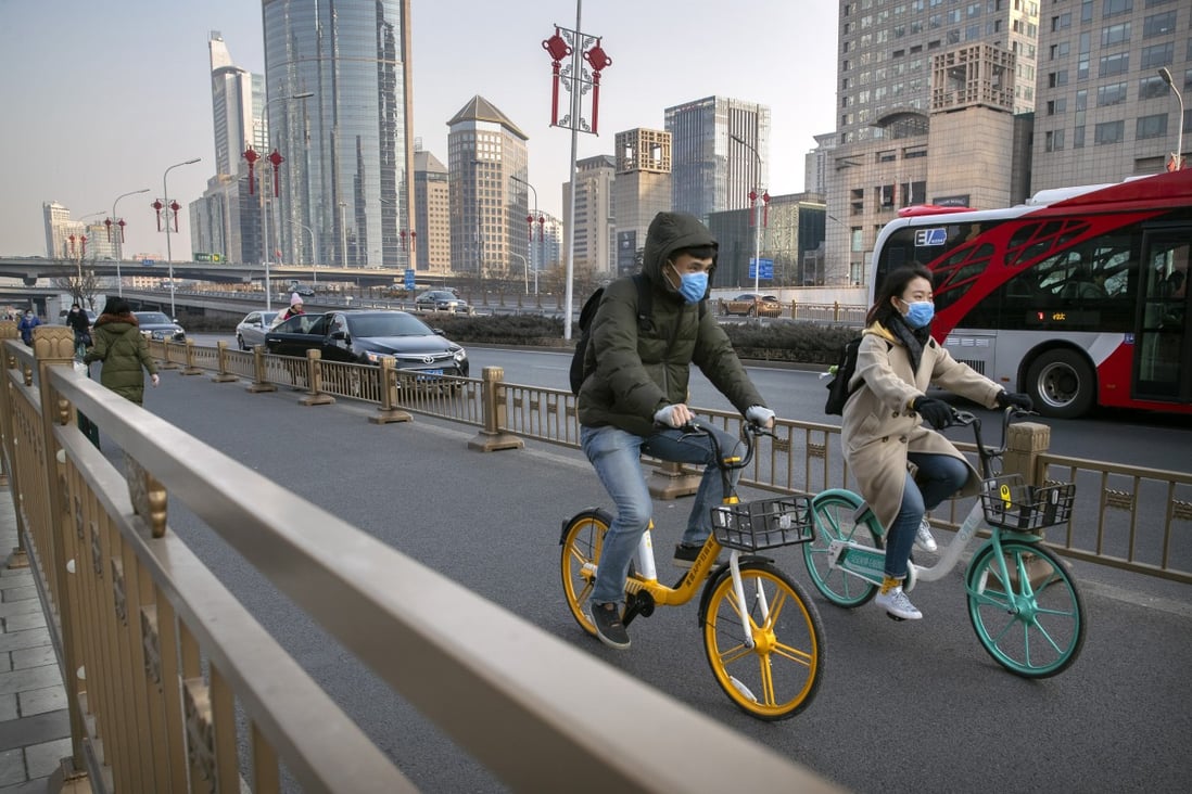 Cyclists wear masks in Beijing amid a coronavirus outbreak in China. The Shanghai Composite, Shenzhen Component and ChiNext indices all rose on Wednesday. Photo: AP