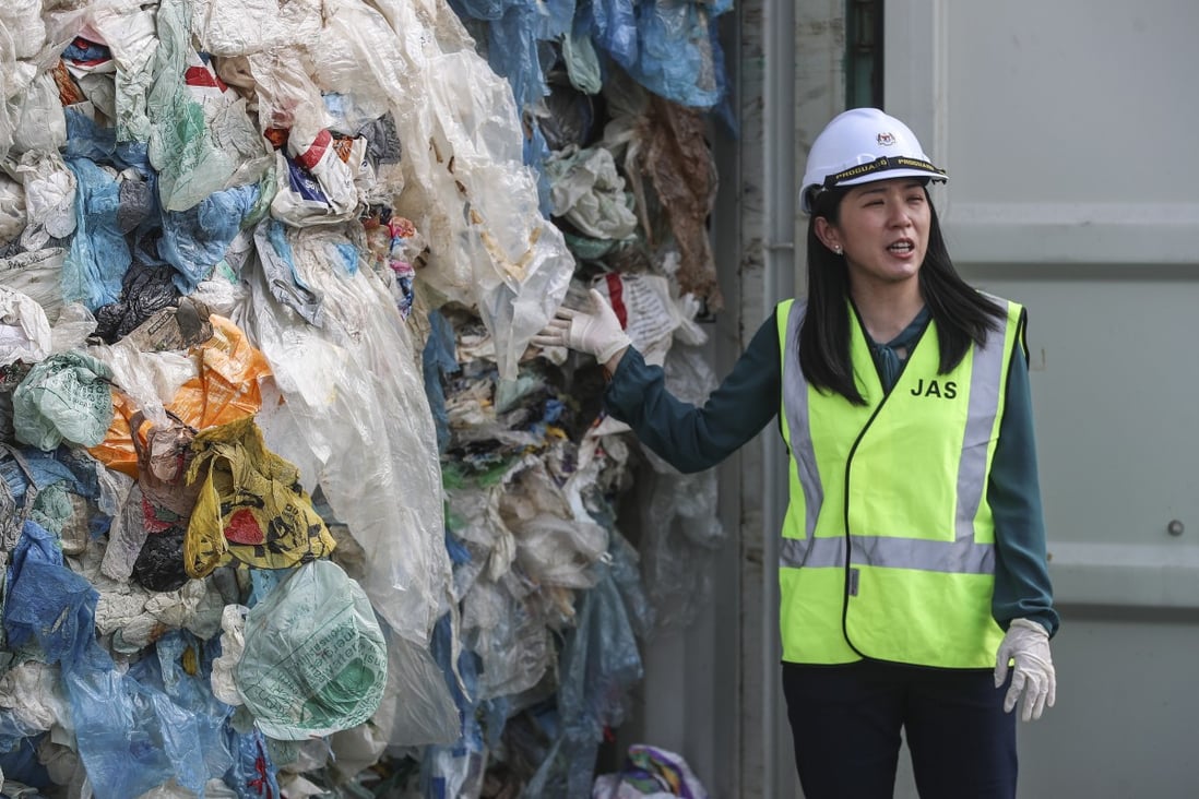 Malaysia's environment minister Yeo Bee Yin stands beside a container full of plastic waste just before it is shipped back to its country of origin. Photo: EPA-EFE