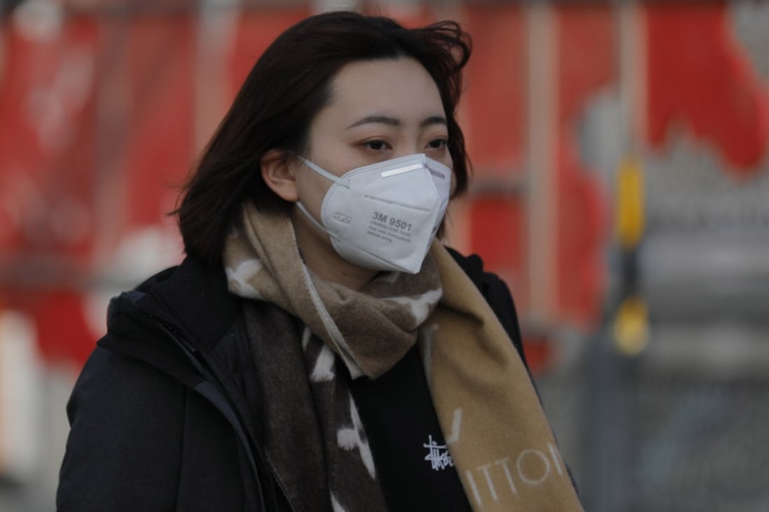 A woman wearing a mask in Beijing recently as a precaution against the coronavirus. Photo: EPA-EFE