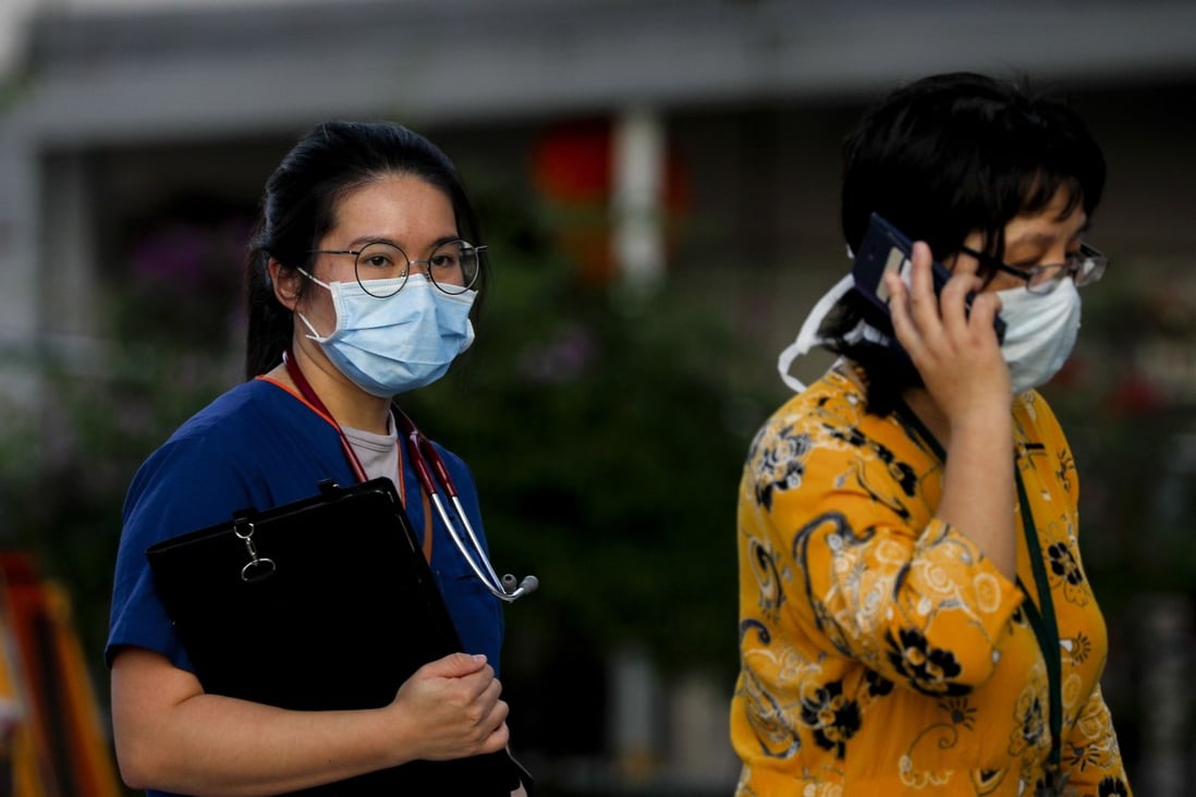 A nurse and a visitor at Singapore General Hospital. The island nation has confirmed four cases of the coronavirus, all of which are travellers from Wuhan. Photo: EPA