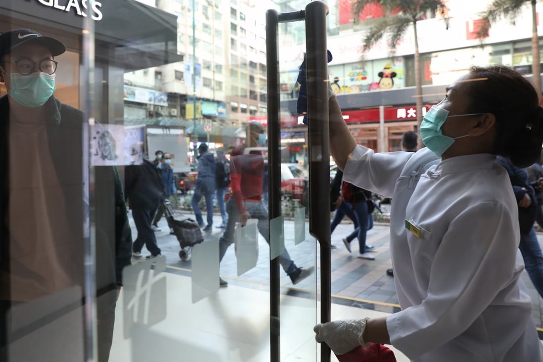 A cleaner sanitising the door at the Holiday Inn in Tsim Sha Tsui on Thursday, amid the coronavirus outbreak. Photo: Winson Wong