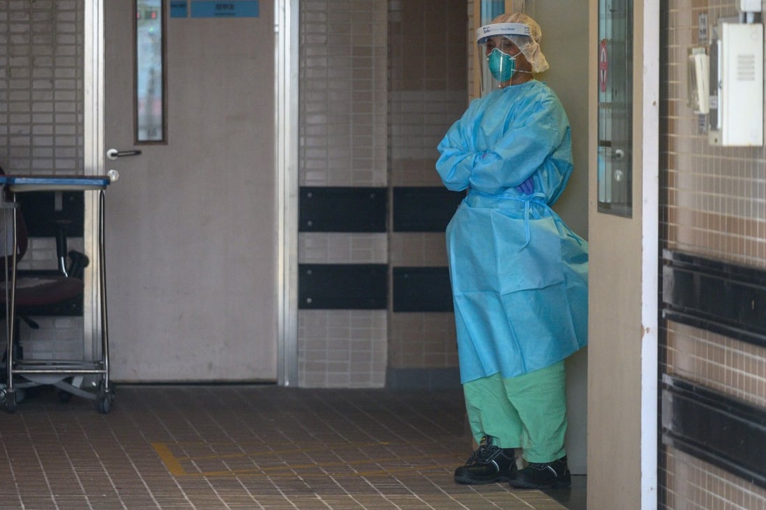 A hospital worker in protective clothing stands at an entrance to Princess Margaret Hospital, where 23 nurses called in sick on Wednesday. Photo: AFP