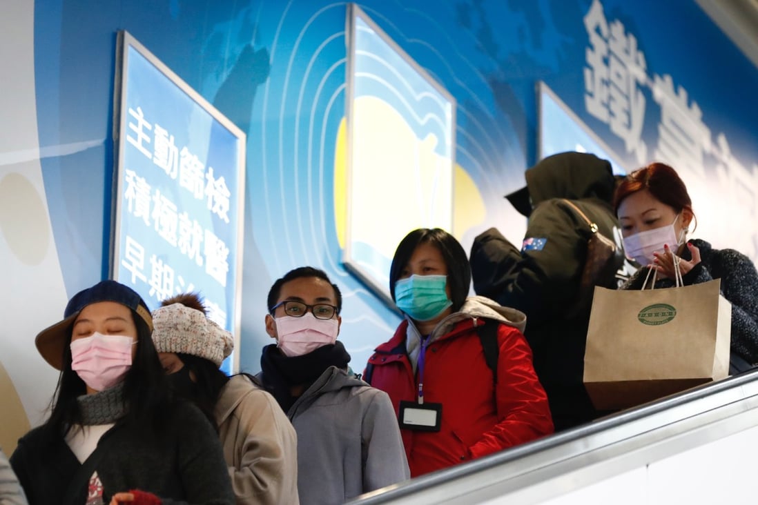 Protective masks on as people use an escalator in Taipei on January 30. Photo: EPA-EFE
