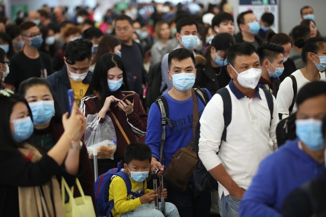 Travellers wearing masks queue at the West Kowloon high-speed railway station, in Hong Kong, on January 23. Photo: Winson Wong