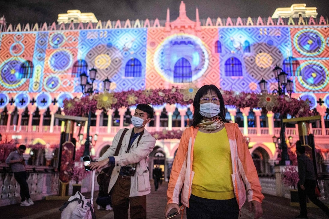 Visitors wear face masks as they walk outside the Venetian casino hotel resort in Macau, which on Januar 22 reported its first case of the novel coronavirus. Photo: AFP