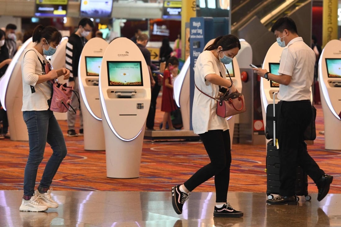 Travellers wearing face masks at Changi International Airport in Singapore. Photo: AFP