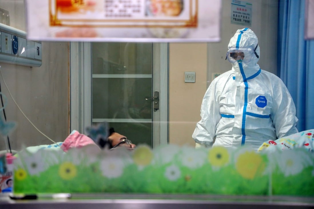 A doctor checks on a patient in the isolation ward of a hospital in Wuhan, Hubei province, on Thursday. Photo: EPA-EFE