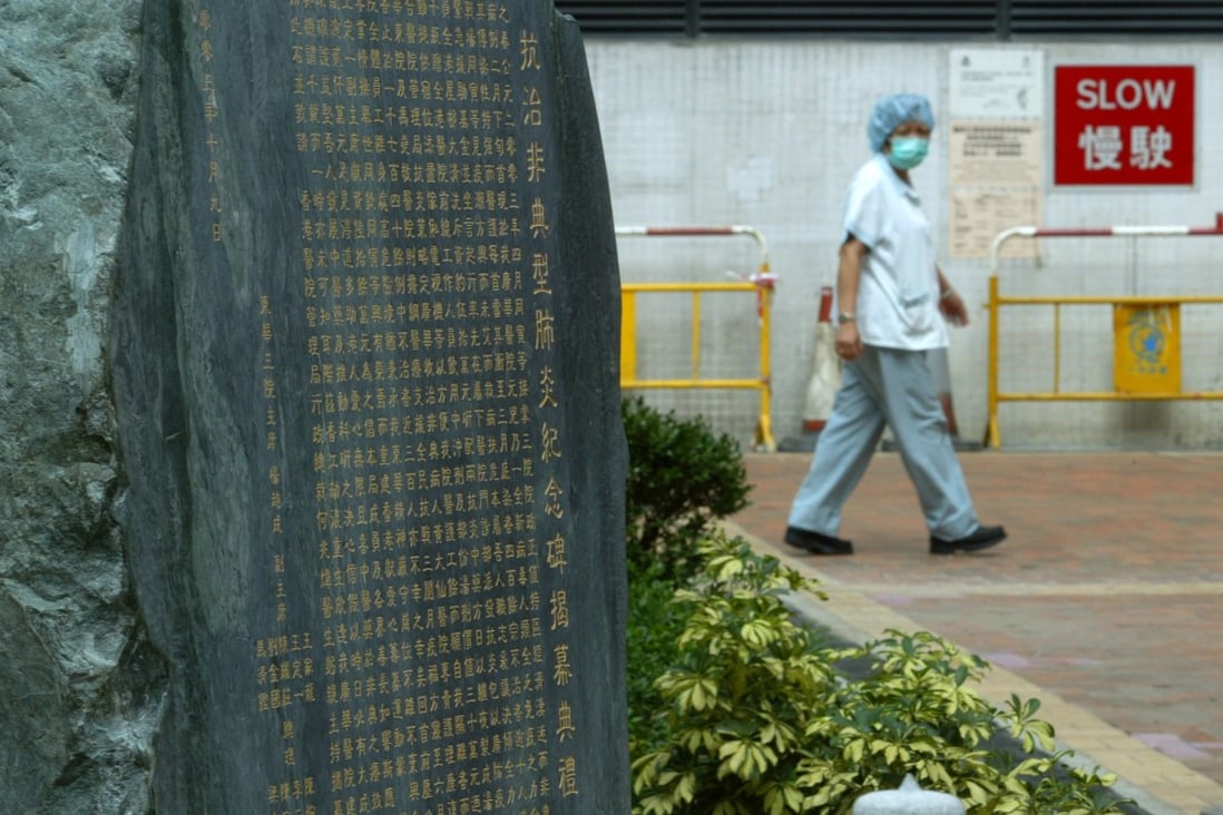 A worker walks past a plaque at Kwong Wah Hospital commemorating Sars victims. Photo: SCMP Pictures