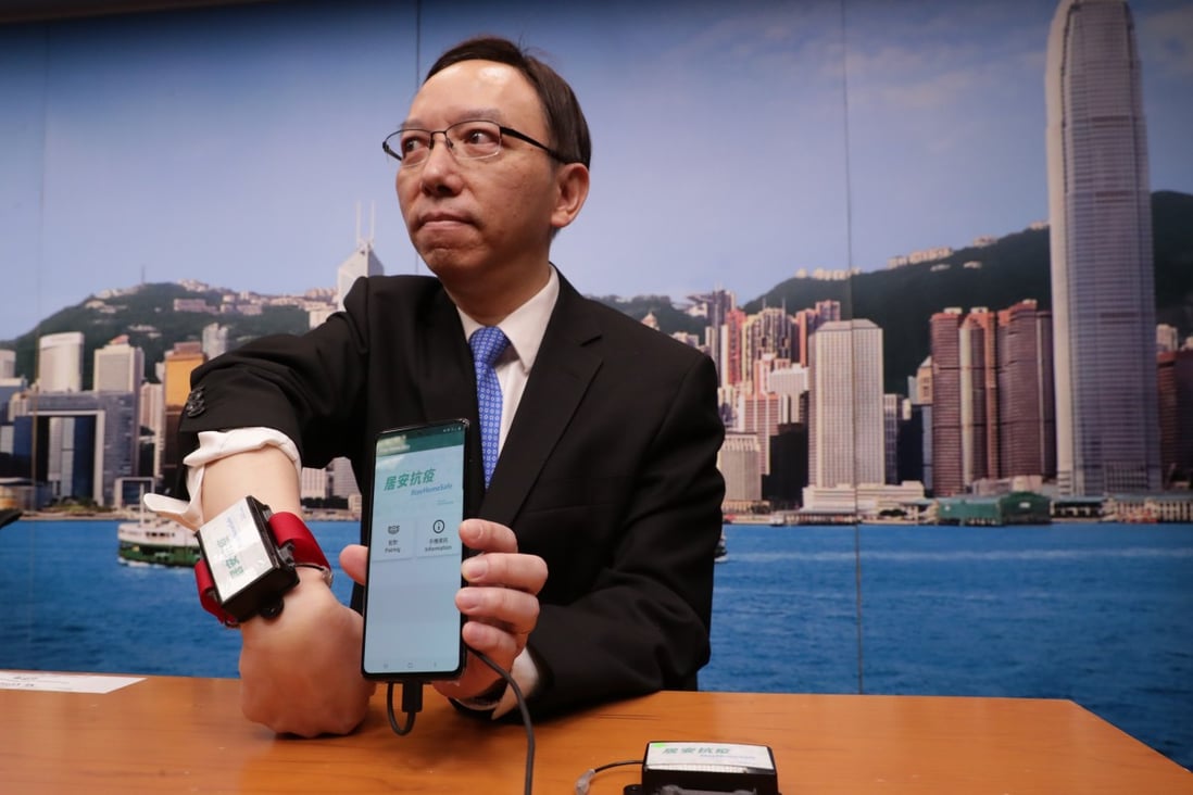 Victor Lam, the government’s chief information officer, displays the devices to be used by the quarantined families. Photo: Edmond So