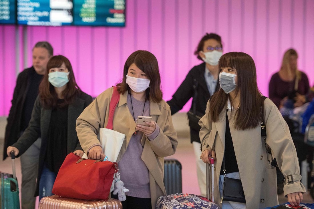 Passengers wear face masks to protect against the novel coronavirus, as they arrive at Los Angeles International Airport on January 22. Photo: AFP