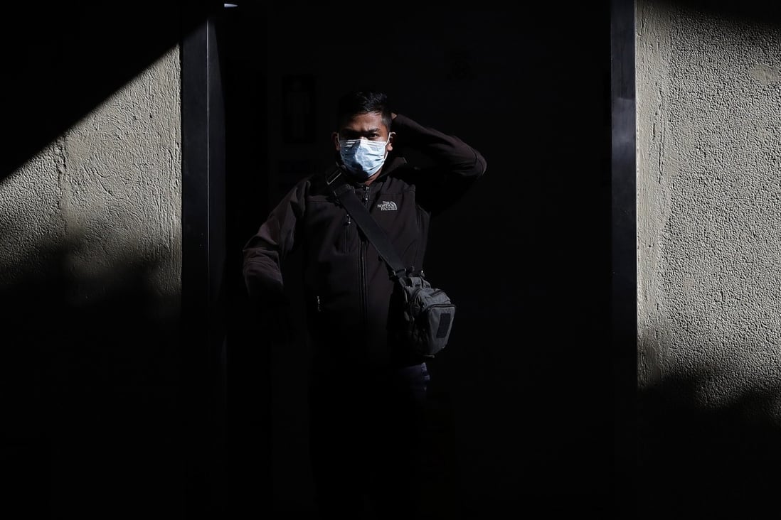 A man wearing a protective mask walks through Manila's international airport. Photo: AP