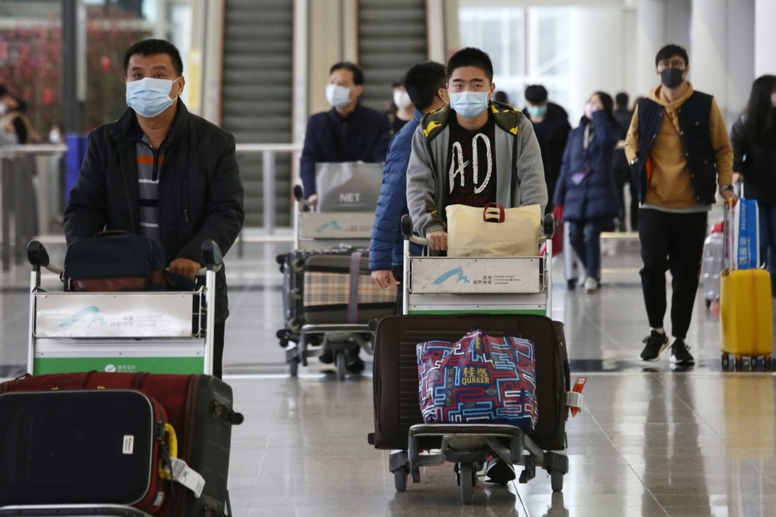 Masked travellers arrive at the Hong Kong International Airport amid the deadly coronavirus outbreak. Photo: Jonathan Wong