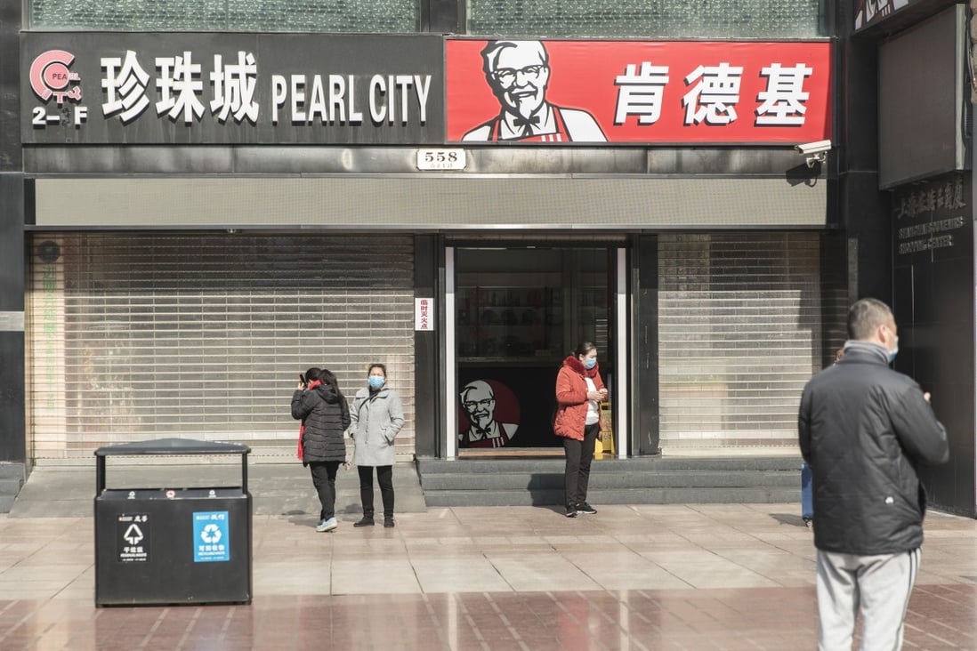 Pedestrians wear protective masks in Shanghai on Wednesday. Yum China’s same-store sales grew 3 per cent year on year in 2019, driven by KFC. Photo: Bloomberg