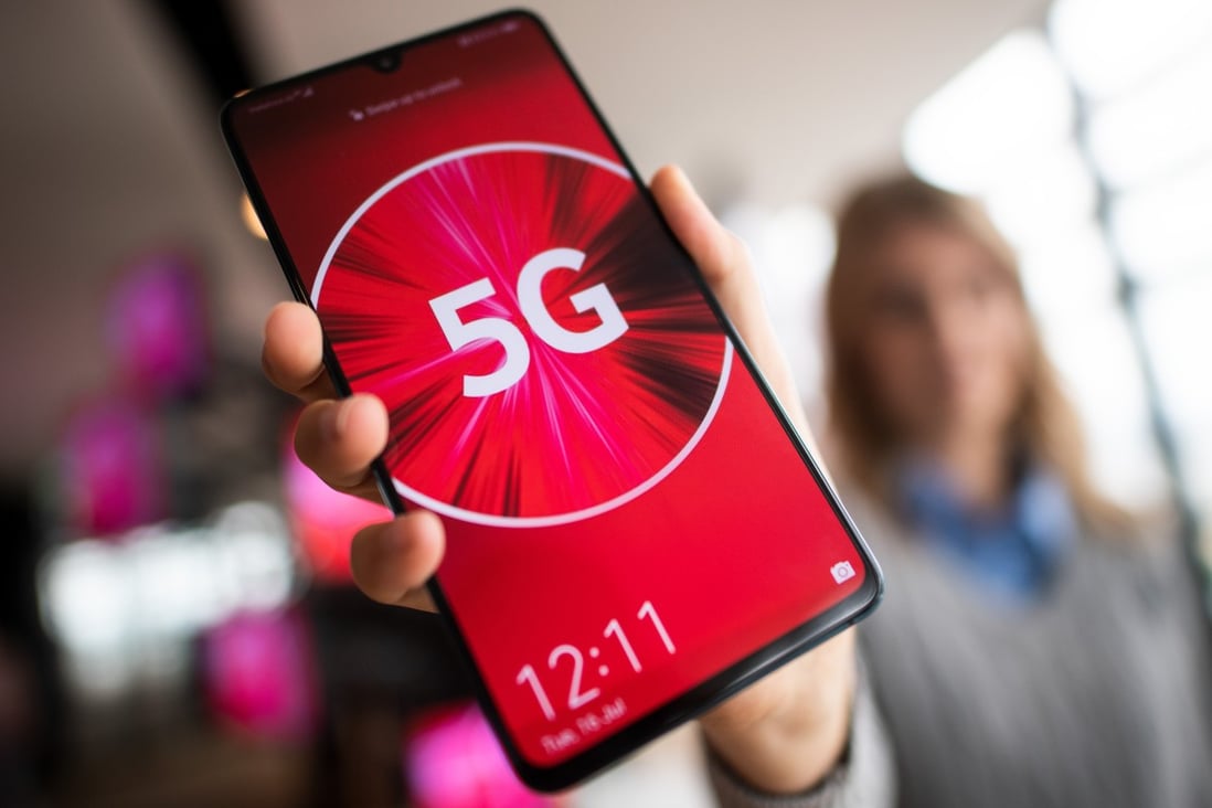 A Vodafone employee holds a 5G smartphone. The company was the first German telecommunications company to launch a commercial 5G network. Photo: Federico Gambarini/dpa