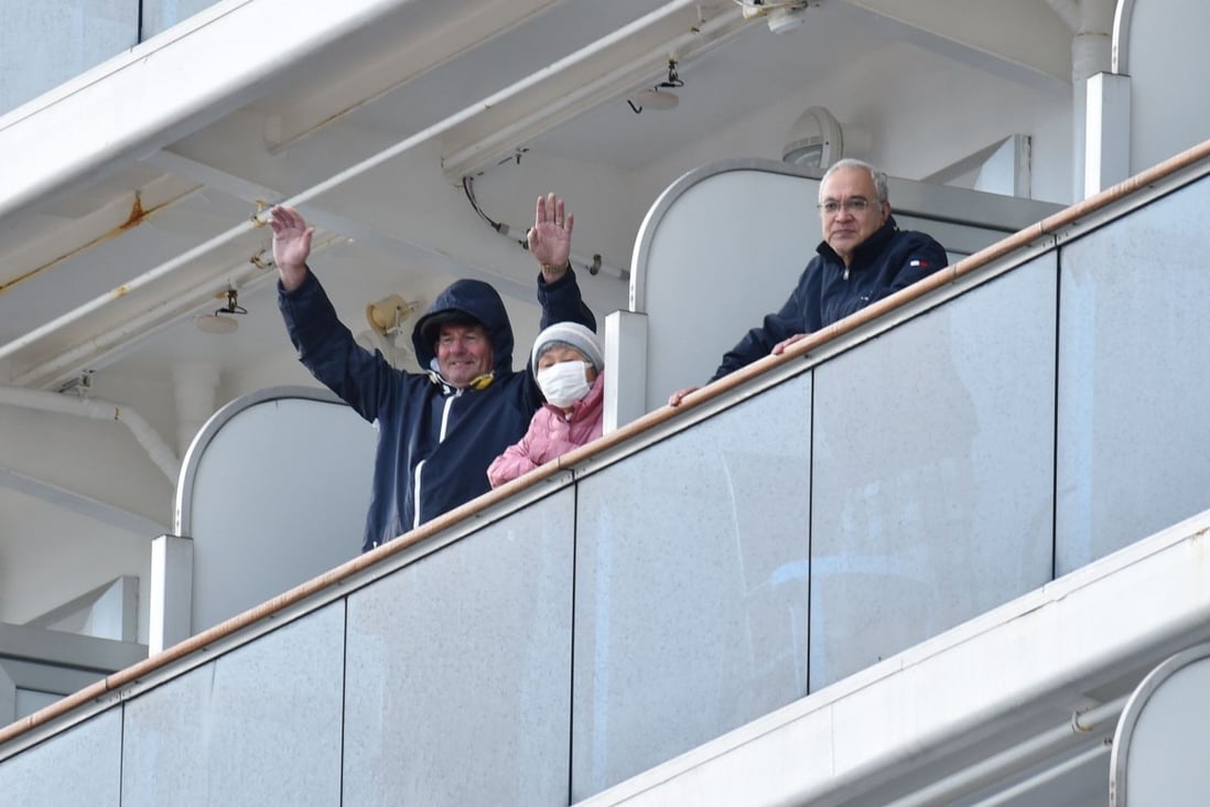 Passengers aboard the Diamond Princess cruise ship wave to the media. Photo: AFP