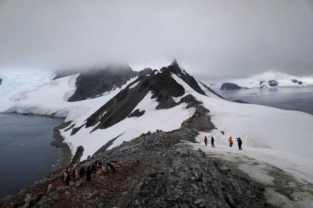 People walk along Orne Harbour, Antarctica, on February 6. The melting of Antarctic ice is causing sea levels to rise 3mm a year, a process that will only speed up as the region records higher temperatures. Photo: Reuters