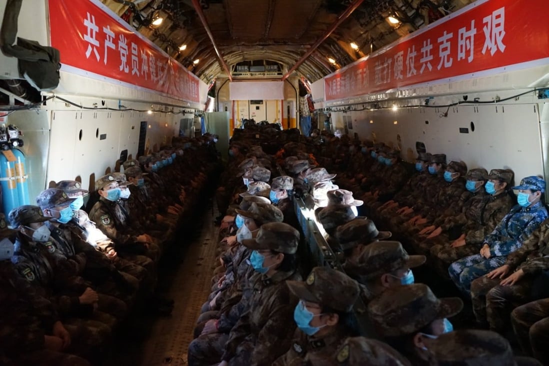 Military medical staff fly into Wuhan on an air force transport plane last weekend. Photo: Xinhua