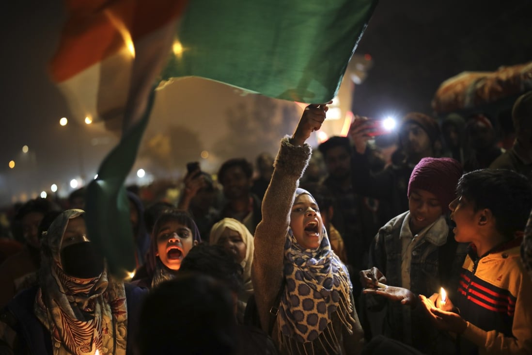 A girl waves the Indian national flag as she shouts slogans during a protest against a new citizenship law in New Delhi. Photo: AP
