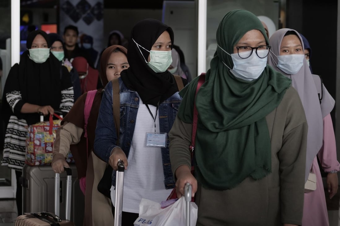 Airline passengers in face masks seen at an airport in Cengkareng on February 1, 2020. Photo: Getty Images/TNS