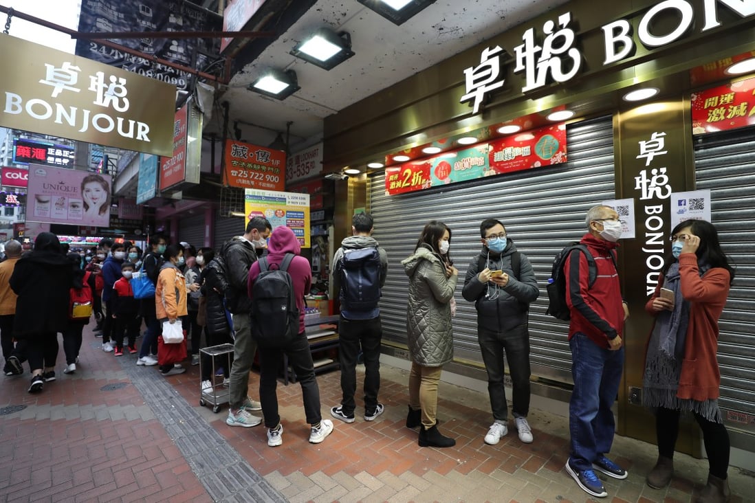Shoppers queue for surgical masks outside of a shop in Causeway Bay. Photo: Xiaomei Chen