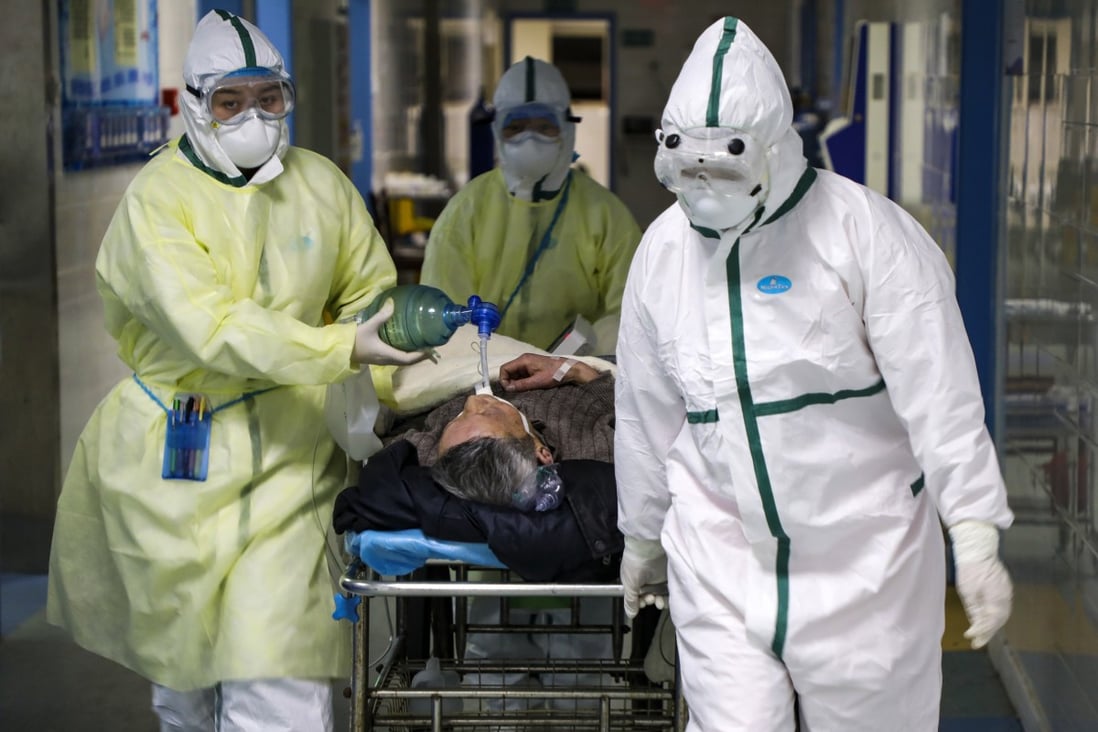 Medical workers transfer a patient in the isolation ward for coronavirus patients at a hospital in Wuhan, the epicentre of the outbreak. Photo: AP