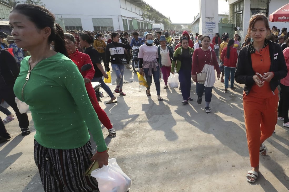 Workers at a garment factory near Phnom Penh walk out at the end of their shift on Tuesday. Photo: AP