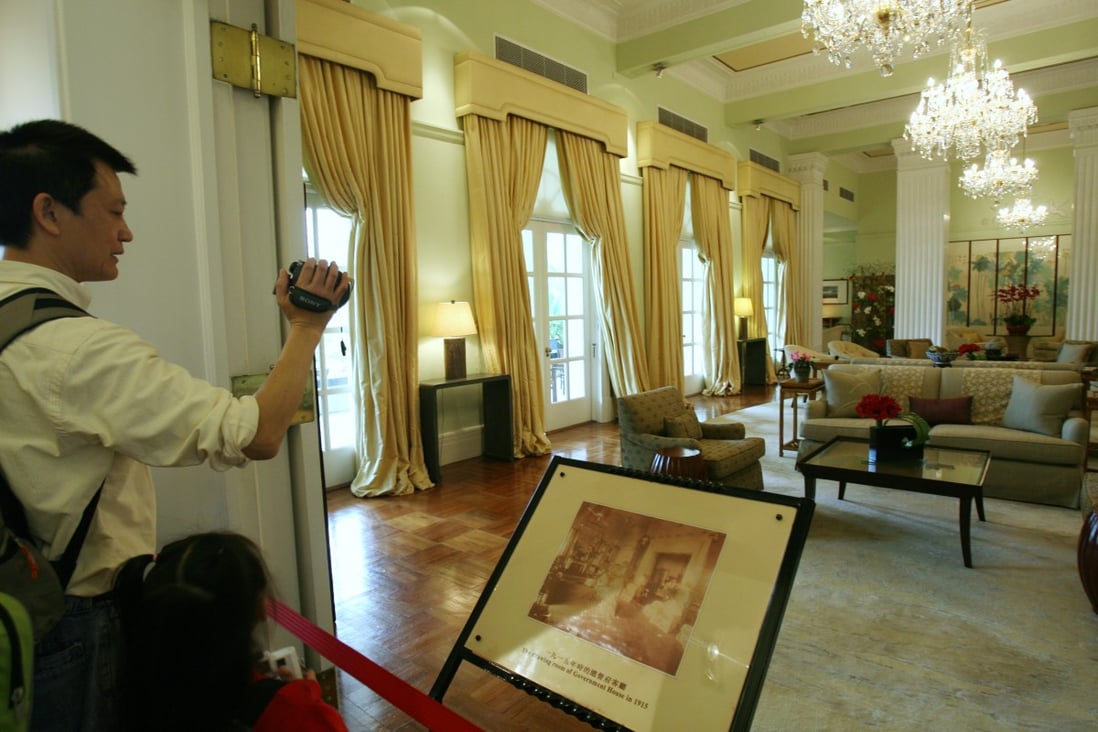 A visitor takes a picture of the drawing room in Government House. In Hong Kong, ‘safe’ interior tastes have always been what sells the best. Photo: SCMP