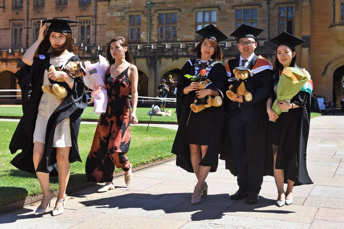 Students from China pose for family photos after graduating from a course at Sydney University in 2017. Photo: AFP