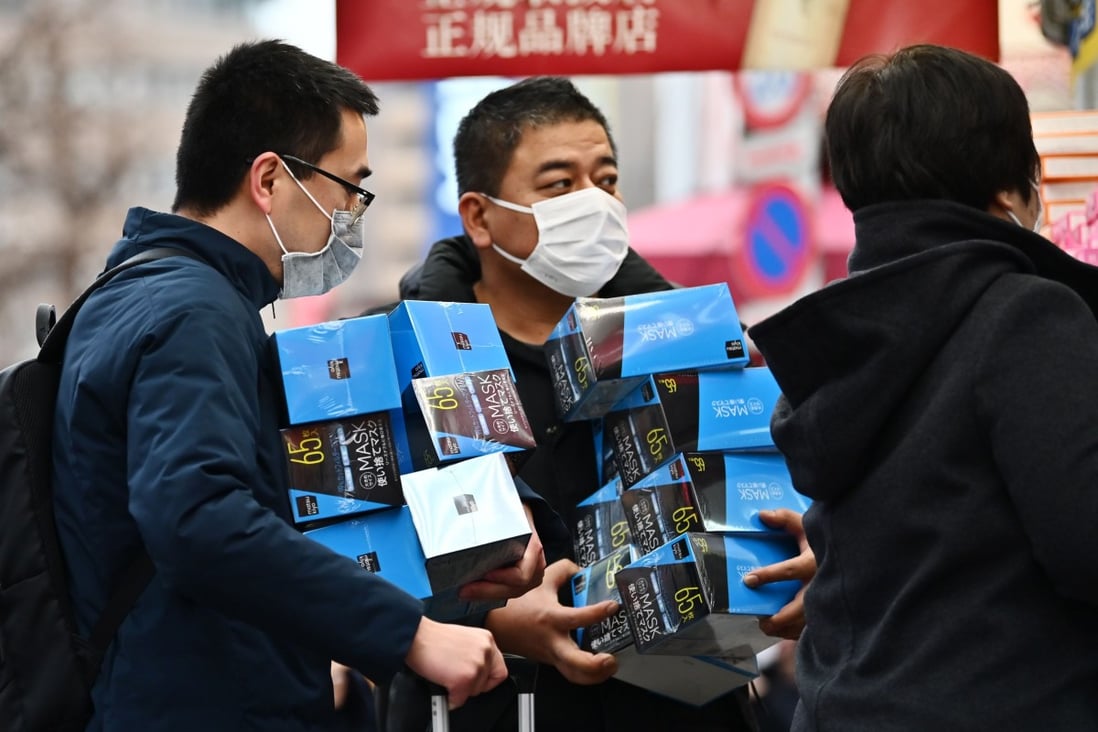 Customers buy face masks in Tokyo's Akihabara area on January 27. Photo: Charly Triballeau/AFP