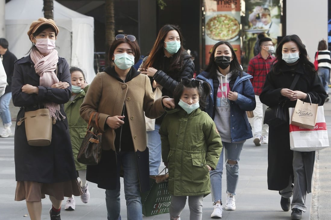 People seen in face masks at a shopping district in Taipei. File photo: AP