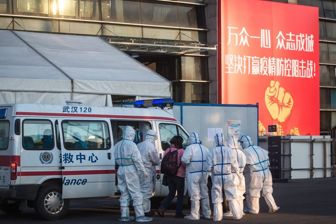 Medical staff admit a coronavirus patient to a temporary hospital set up at Wuhan Sports Centre in Wuhan on Wednesday. Photo: Xinhua