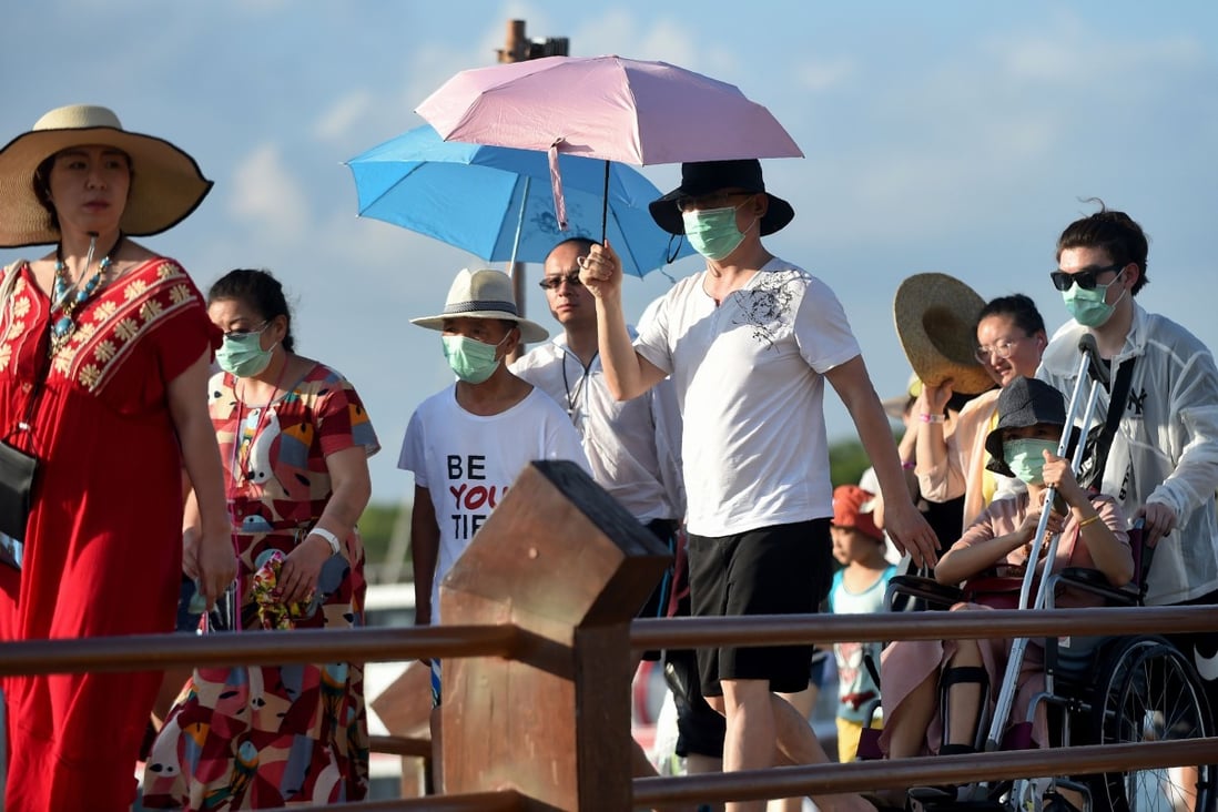 Chinese tourists, some wearing face masks, are pictured on Indonesia's resort island of Bali last month. Photo: AFP
