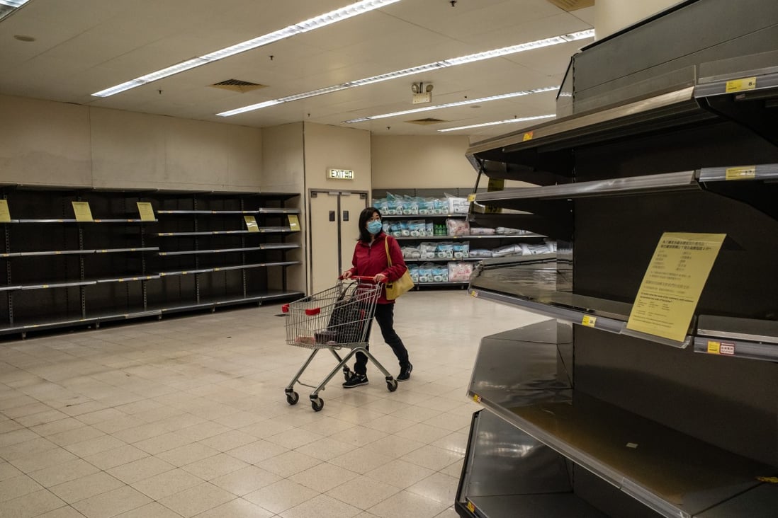 A shopper wearing a face mask pushes a shopping trolley past empty shelves inside a store in Hong Kong earlier this month. Photo: TNS