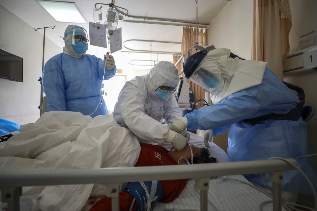 Medical workers treat a new coronavirus patient in Wuhan, still the focal point of the outbreak. Photo: AP