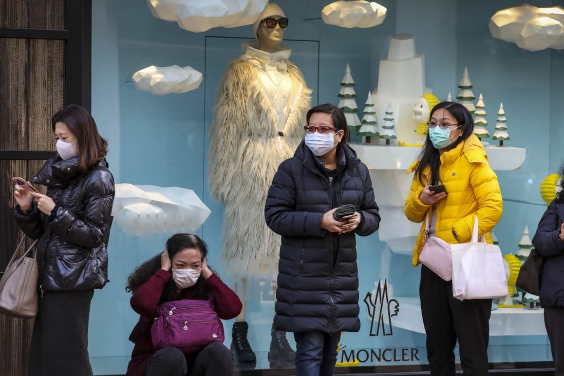 Queues for surgical masks are still forming around Hong Kong, though a new survey suggests they are slowly becoming easier to obtain. Photo: Nora Tam