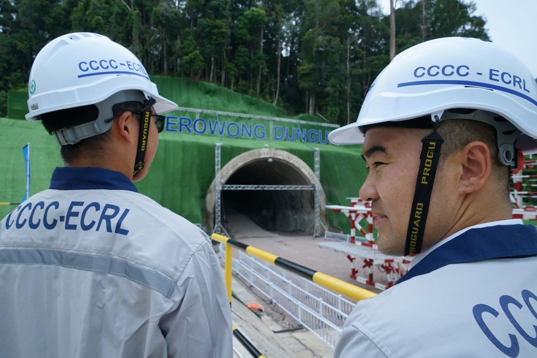 China Communications Constructions Company workers stand in front of a tunnel of the East Coast Rail Link project in July. Photo: AFP